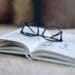 Soft focus glasses, book on the sofa. Abstract book blur background. Concept for education.