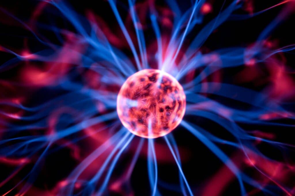 Decoration lamp in shape of plasma ball with red and blue electrodes, close-up