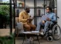African-American businessman talking with his Caucasian colleague in wheelchair