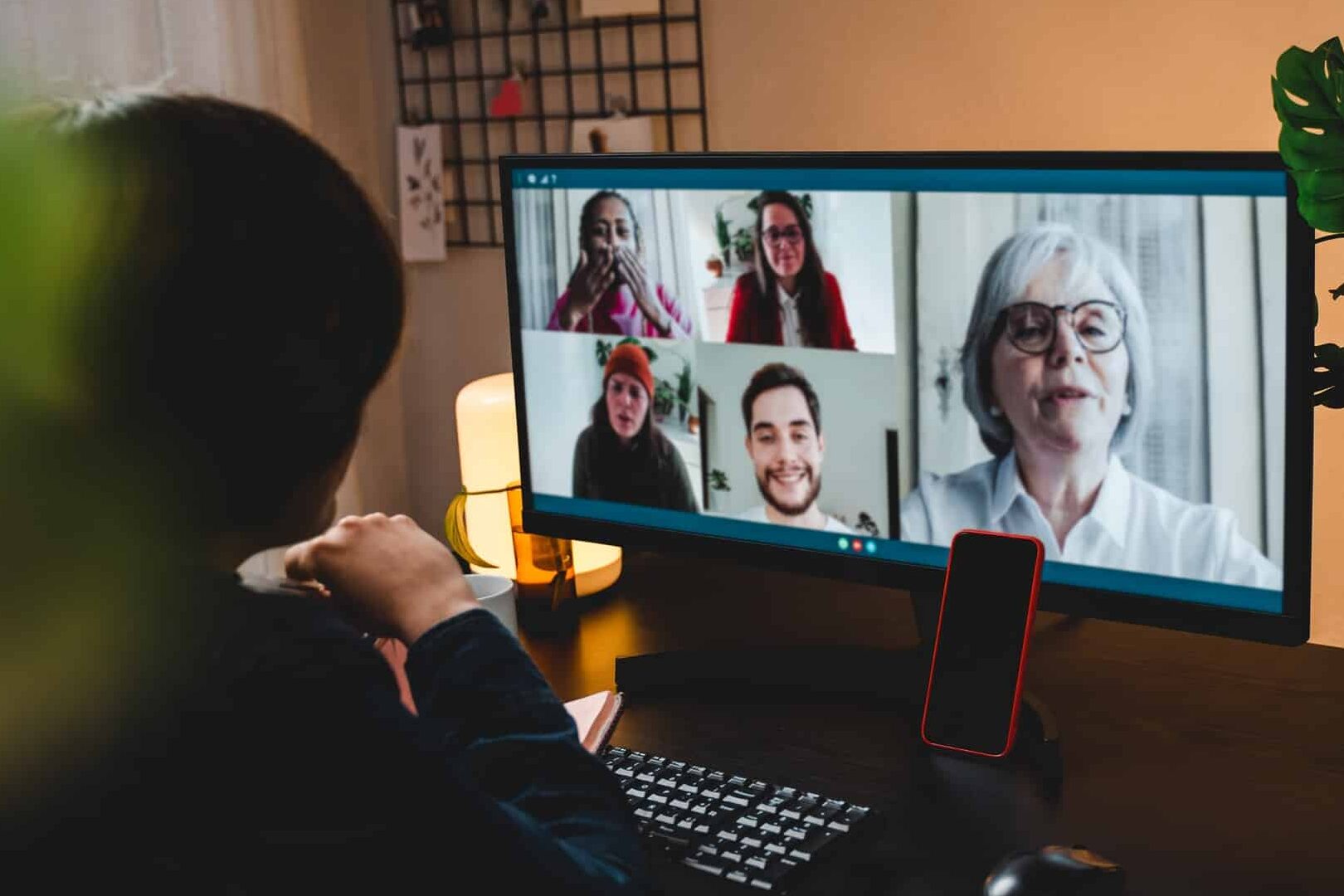 Multi generational business woman having video call with colleagues using computer app