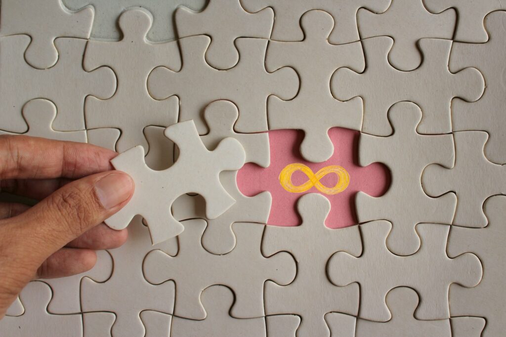 Hand reveal gold infinity symbol on puzzle.